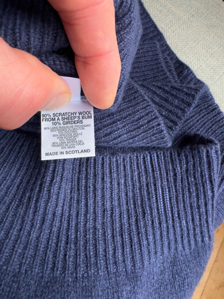 An amended photo of an imminent cardigan by 1of100 claiming that the garment is made of a sheep’s rough bum hair and the Forth Bridge.