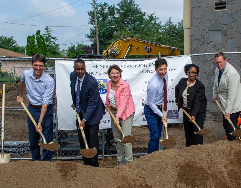 6 people holding shovels for a ceremonial ground breaking event.