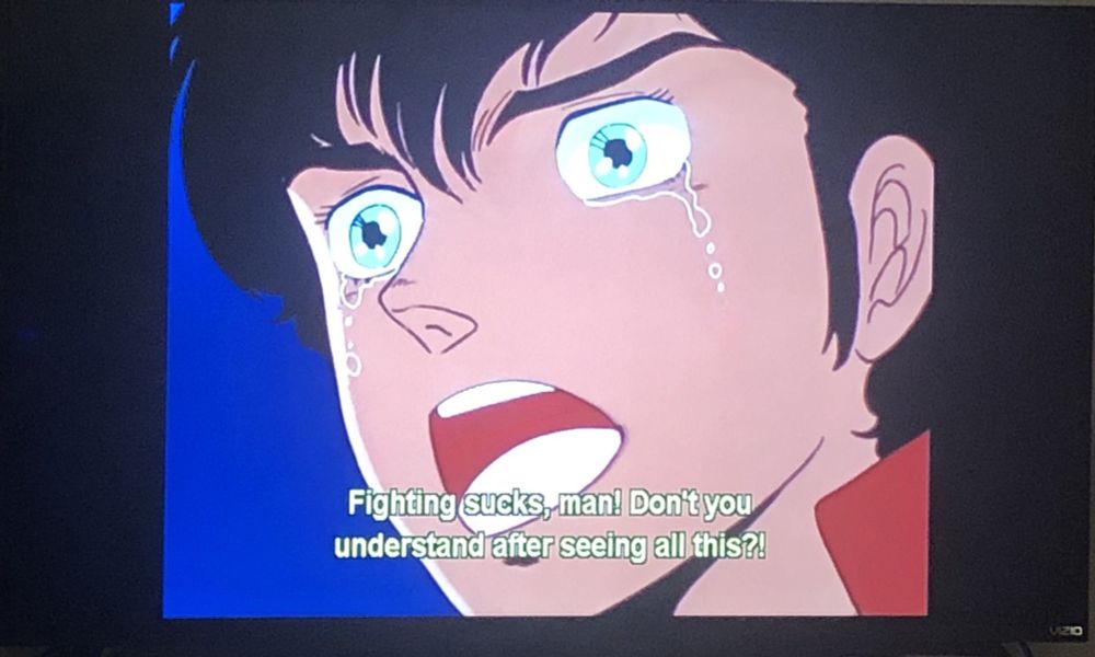 Judau fully crying now, shouting "Fighting sucks, man! Don't you understand after seeing all this?!"