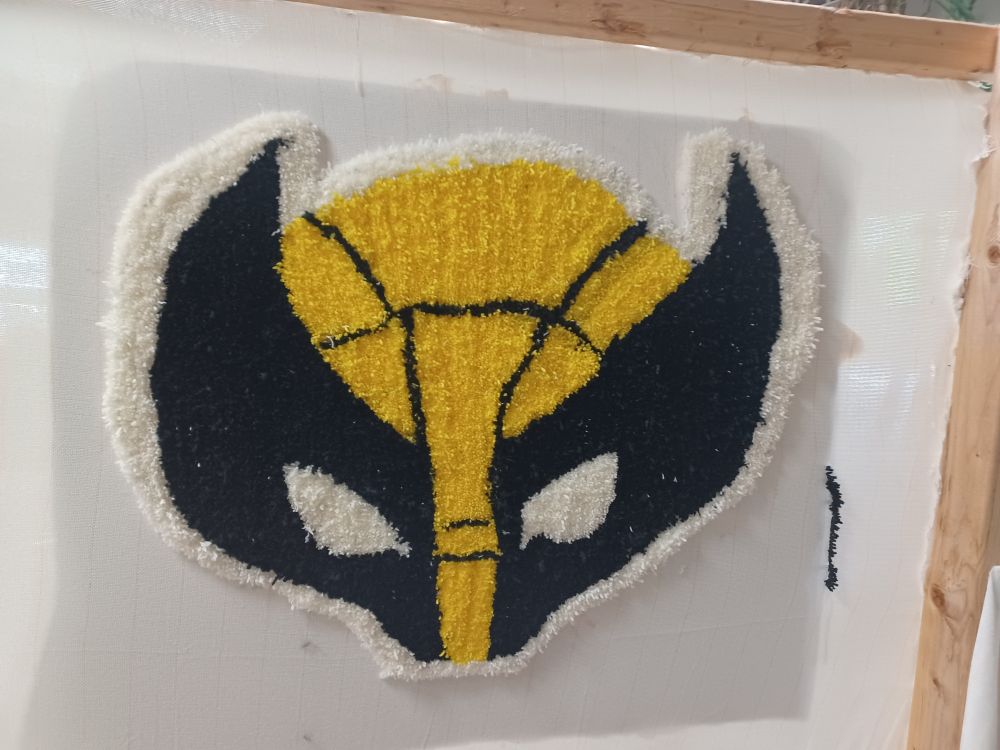 Wolverine cowl made of yarn. It's now a rug in my room >:3