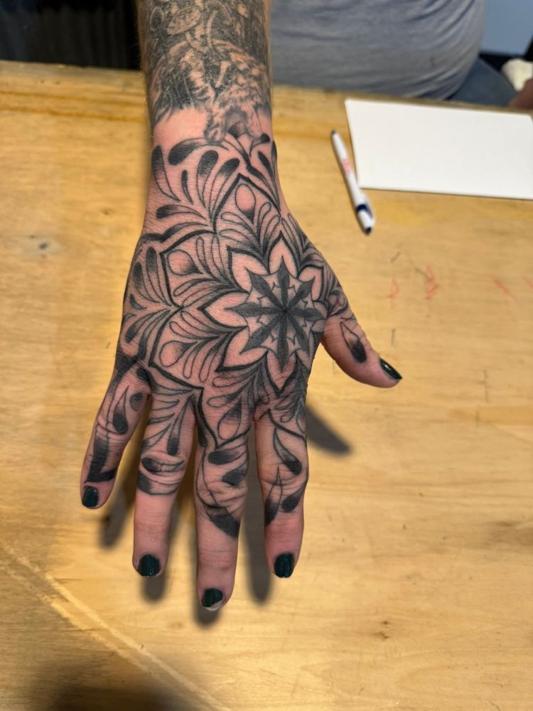 Biased's hand, with a fresh tattoo of a mandala