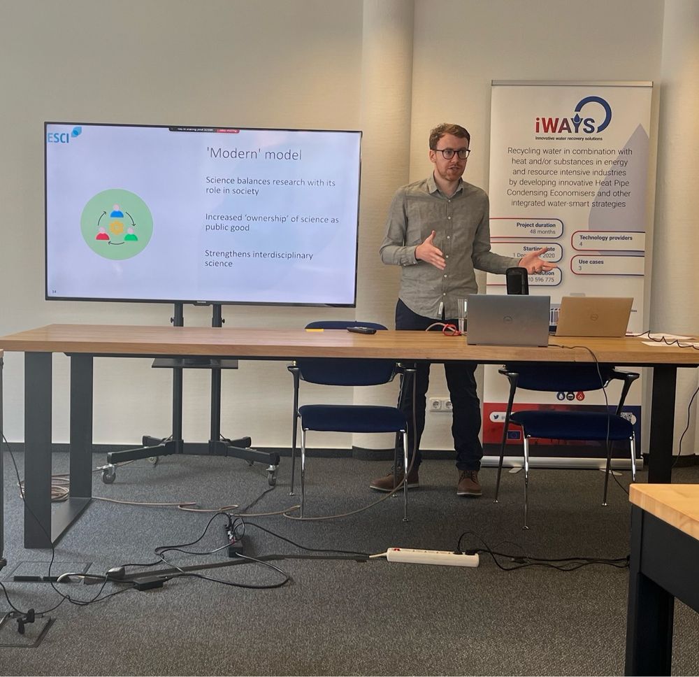 Fintan Burke in front of a large monitor delivering a presentation.