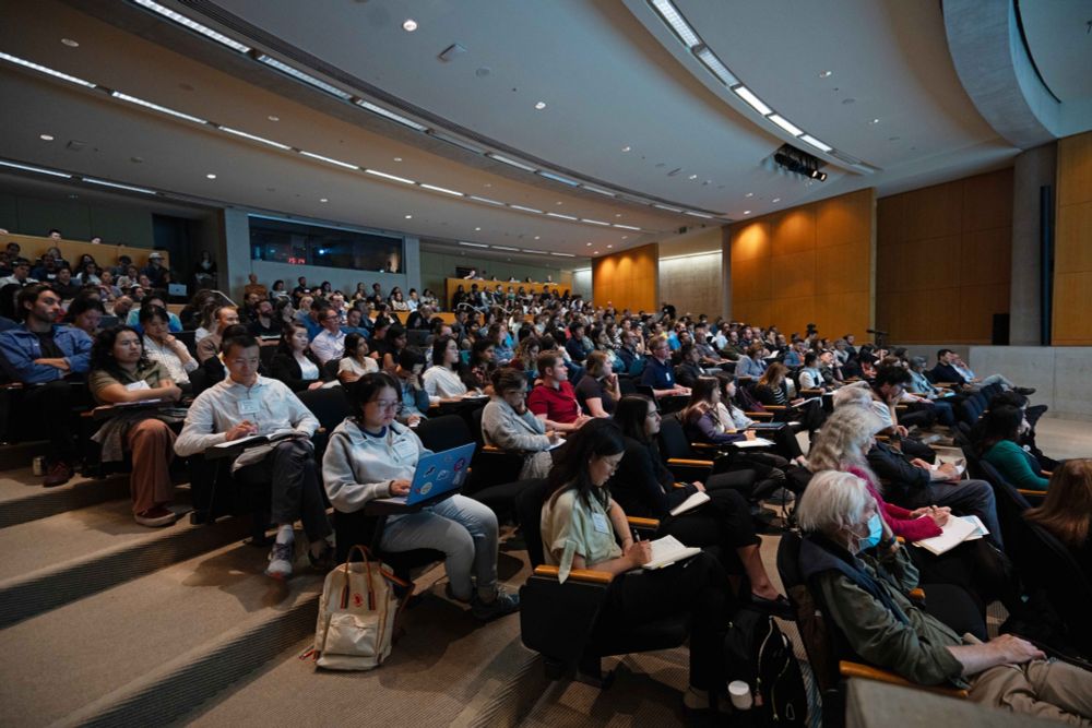 An auditorium with people during a presentation.