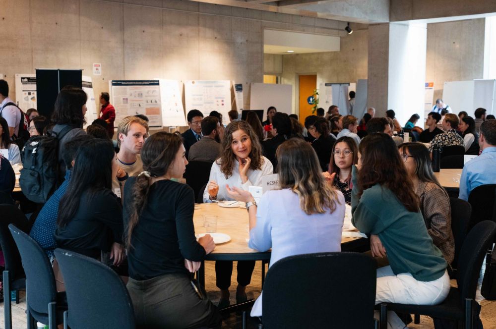 A group of immunologists sitting around a table during a conference.