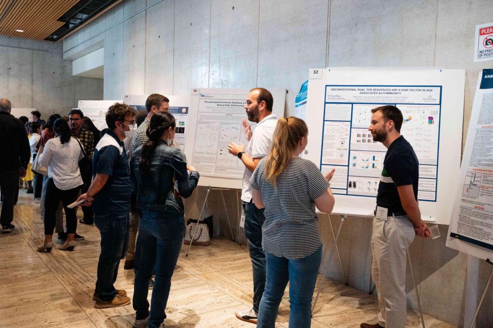 A group of people gathering for a poster session.