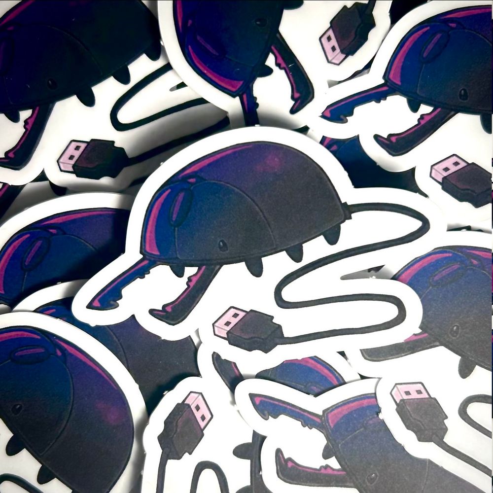 Central Beetle computer mouse sticker on top of several other beetle stickers.