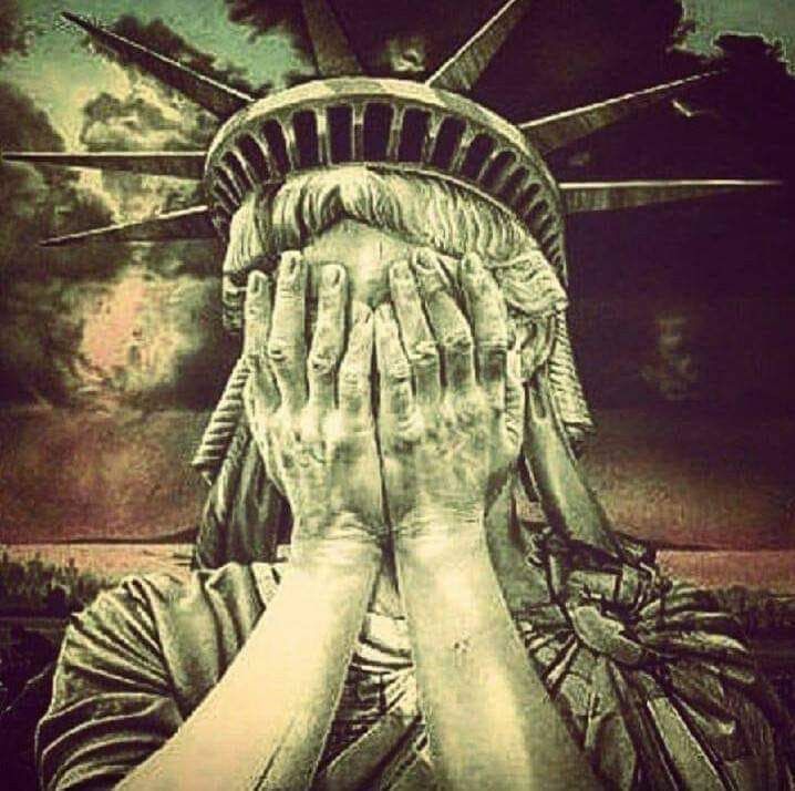 Statue of liberty holding her face and crying