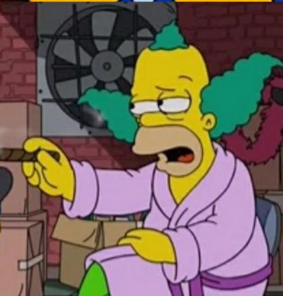 Krusty the Klownnfrom the Simpsons (a tv show). He is in a pink robe with no makeup, looking like Homer 
