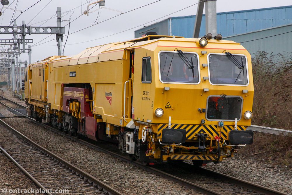 a large yellow railway machine