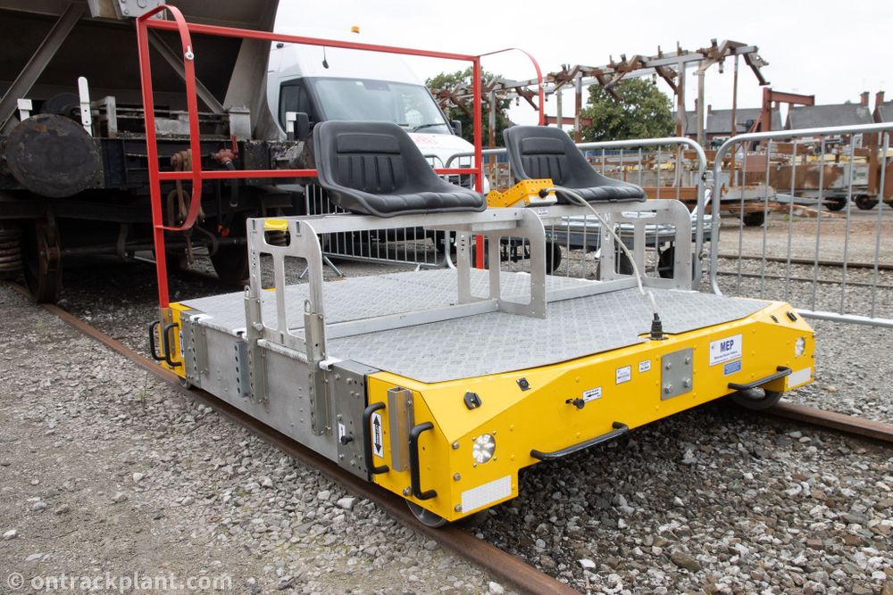 a small motorised rail-mounted trolley with two seats.
