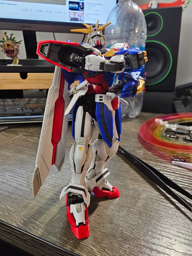 RG God Gundam posed standing with its arms folded across its chest and its head tilted back