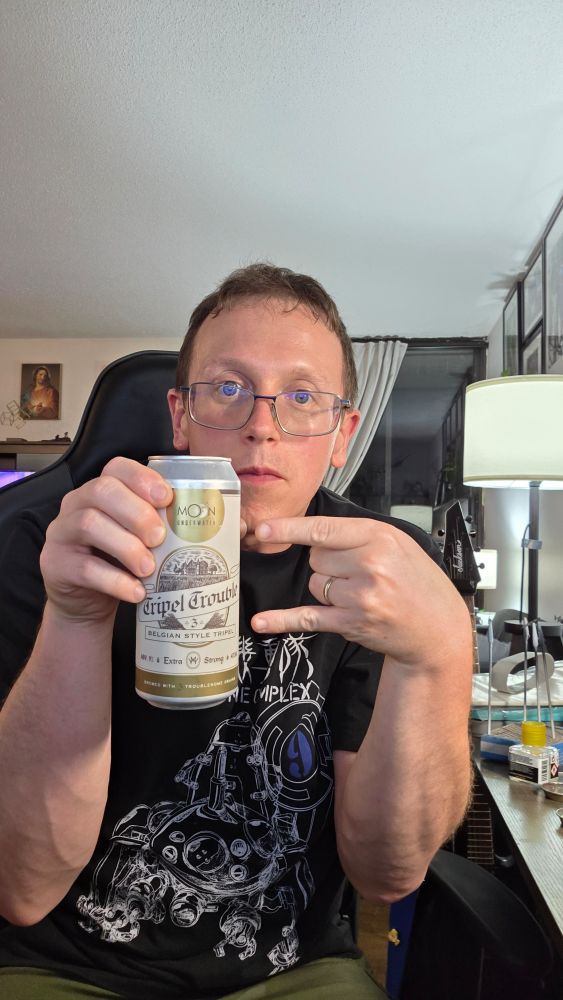 Me, holding a Trippel Trouble Belgian-style trippel from Moon Under Water Brewing.