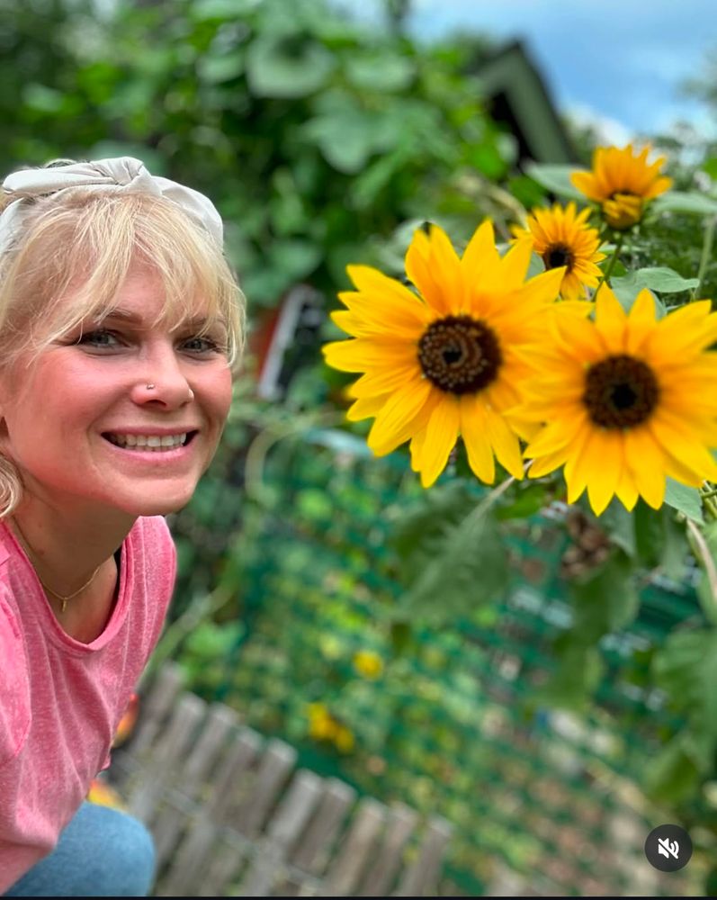 Beth Phoenix posing next to sunflowers