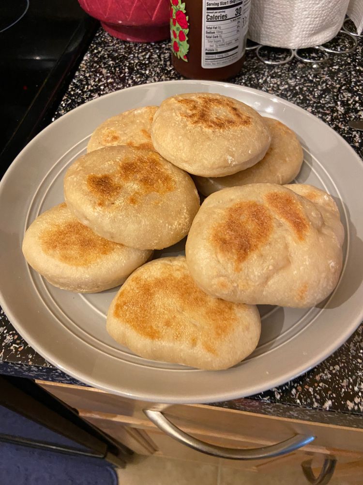 stack of homemade english muffins on a plate