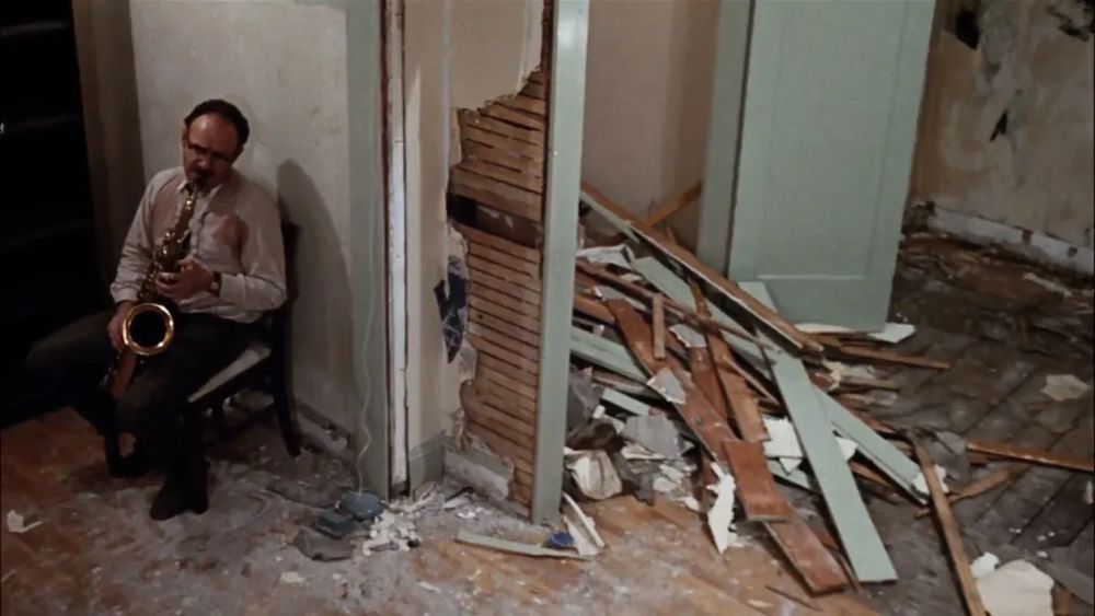 Gene Hackman playing his saxophone in his destroyed home at the end of The Conversation