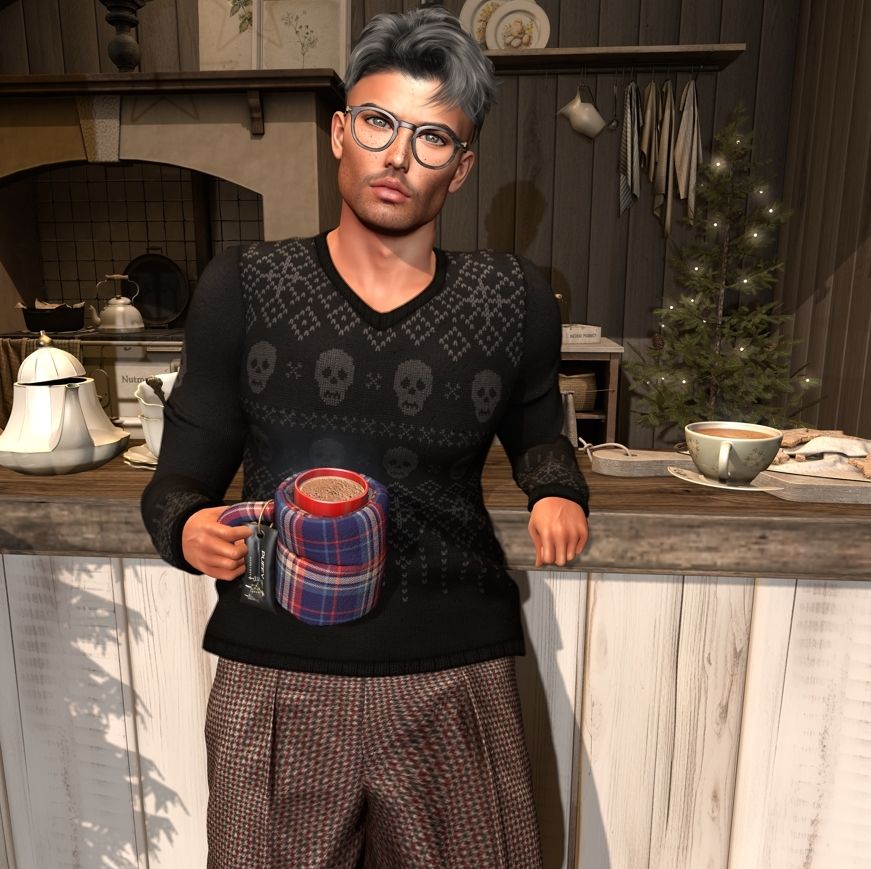 Male #Secondlife avatar leaning on a hot cocoa stand in the winter, wearing a skull holiday sweater, herringbone pants, glasses and holding a puffy coffee cup.