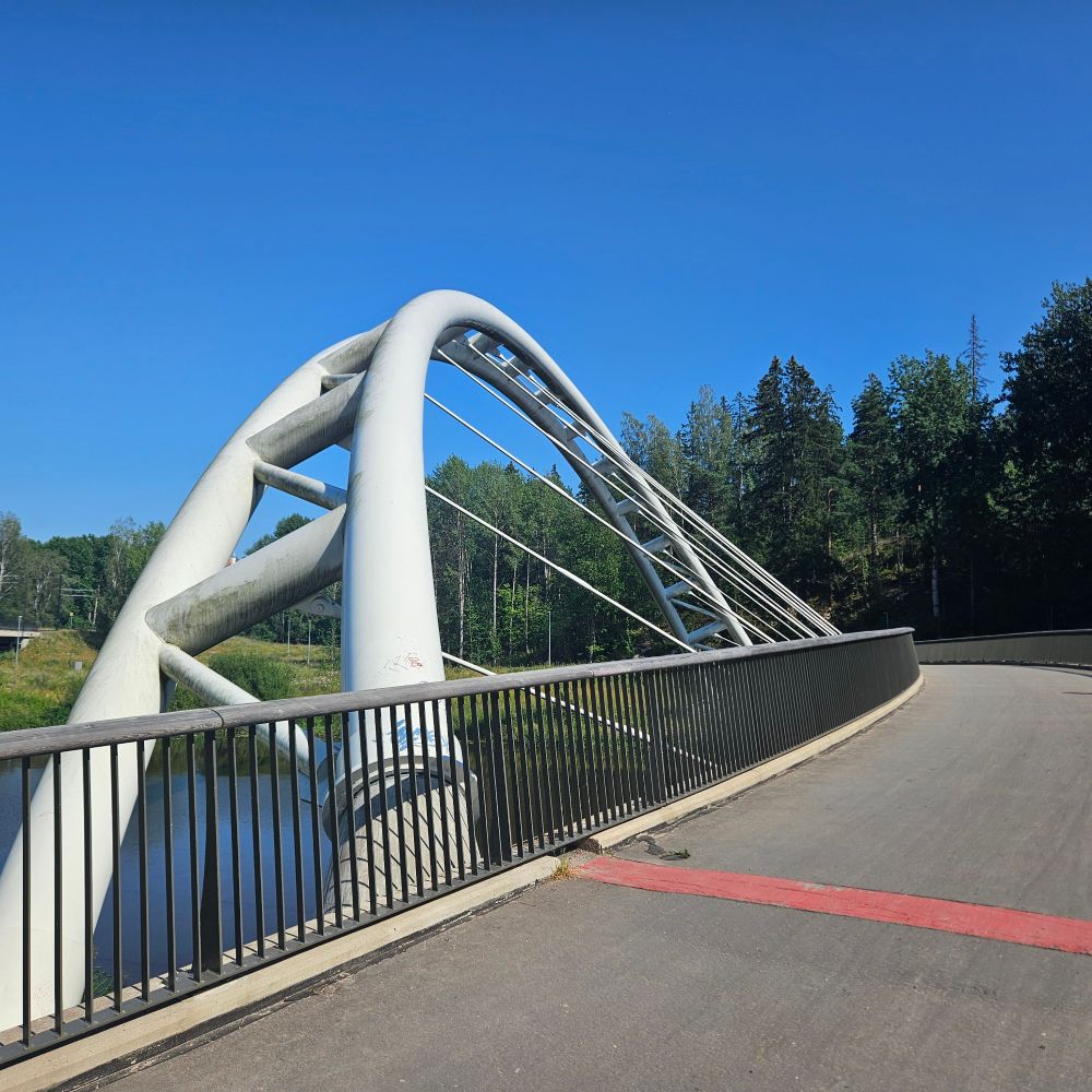 Interesting bridge support structure that arcs out to the left opposite the curving walkway 