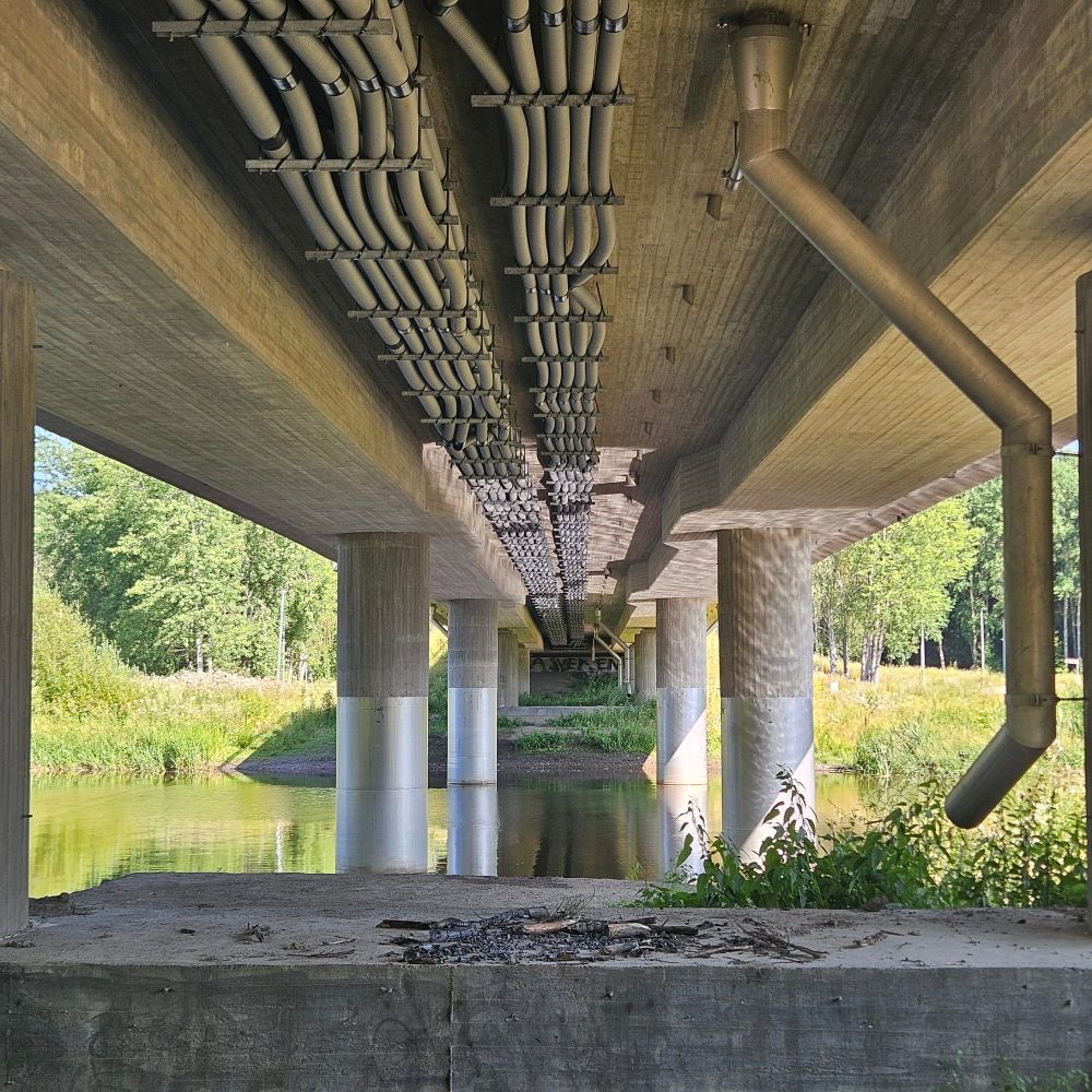 View under a bridges with pleasing pipes and pillars