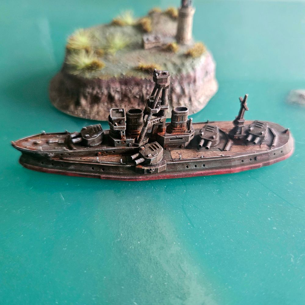Diorama board, close up of a Dreadnought passing in front of a lighthouse 