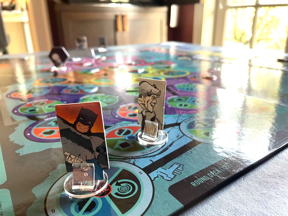 Playing pieces for Batman and Commissioner Gordon stand on the board for Batman: The Dark Knight Returns: The Game
