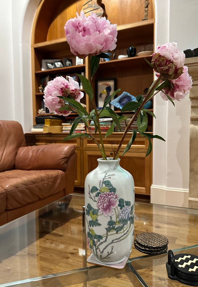 Pink peony flowers in ceramic vase with peonies. 