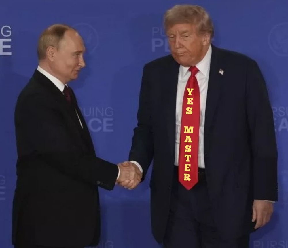 Confident Putin, is giving Trump the eye, Trump looks subdued, timid. They are shaking hands. Trump's tie reads; 
