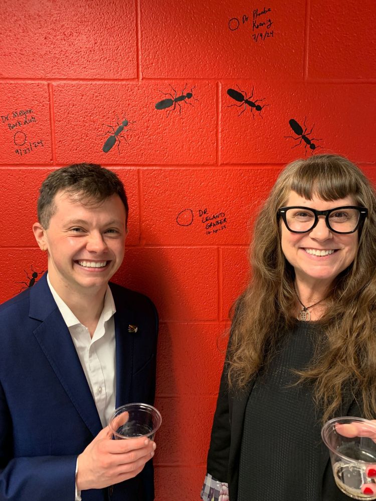 Dr. Leland Graber with Dr. Corrie Moreau in the Moreau Lab after successfully defending his Ph.D.  