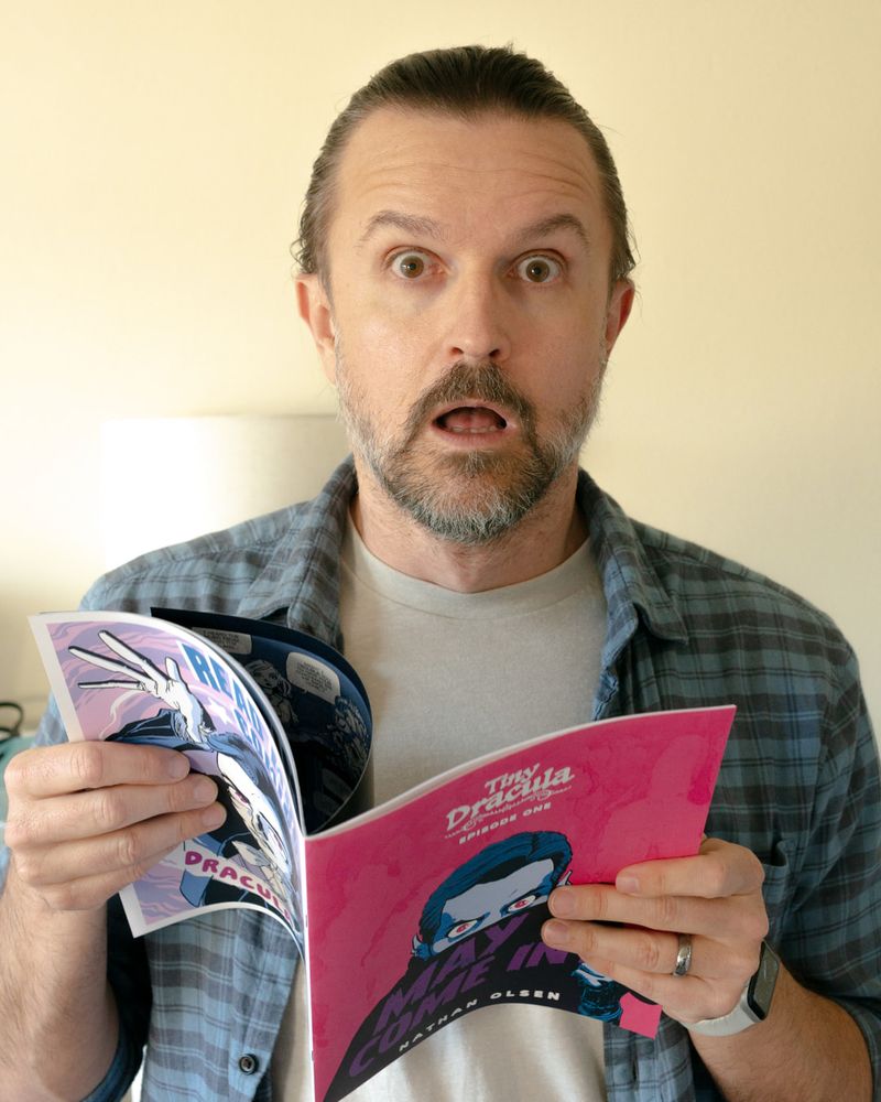 A photo Nathan Olsen holding a copy of his debut comic book, Tiny Dracula #1.