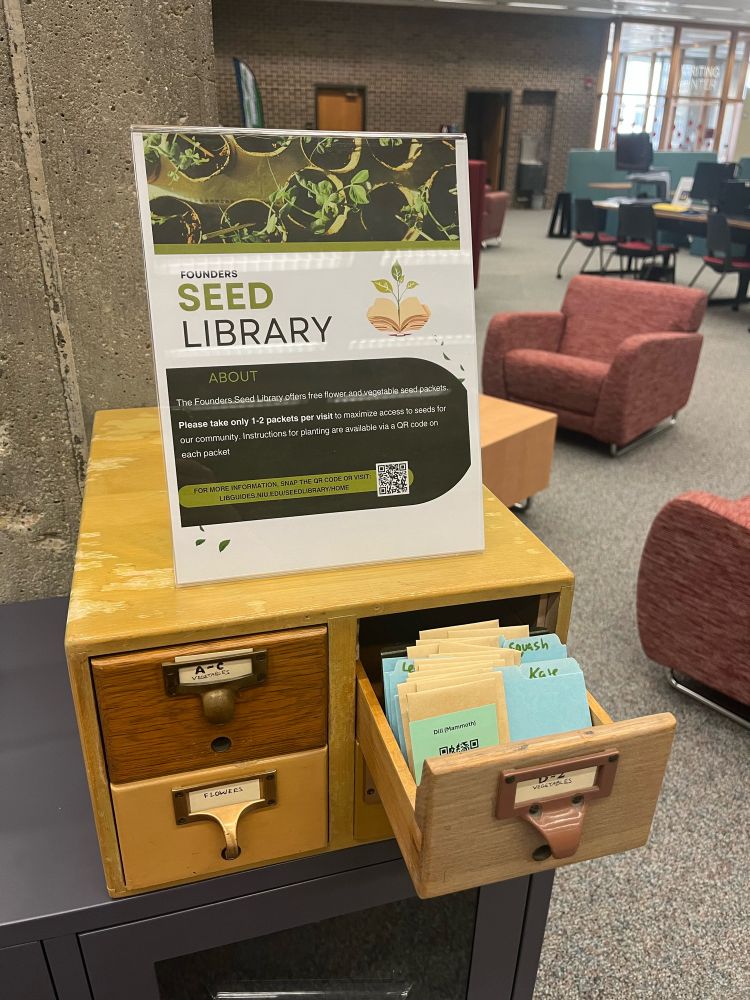 Small card catalog with a sign on top that says “seed library”