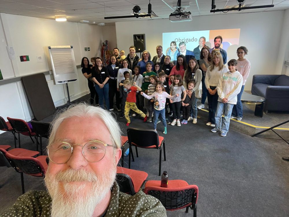 Selfie photo showing a room at the Arts Resource Centre, with Escolinha de Língua Portuguesa, Duarte Bué Alves (Consul General of Portugal in Manchester) and Daniel Gouveia (Honorary Consul of Portugal) in the background, and CAP's ceo, Conor Shields, in the foreground.