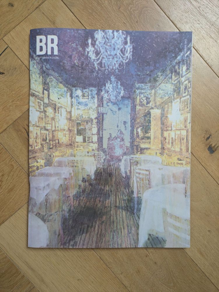 The cover of The Brooklyn Rail, September 2024, with an impressionist painting of a blue and gold cafe with round and square tables covered in white tablecloths
