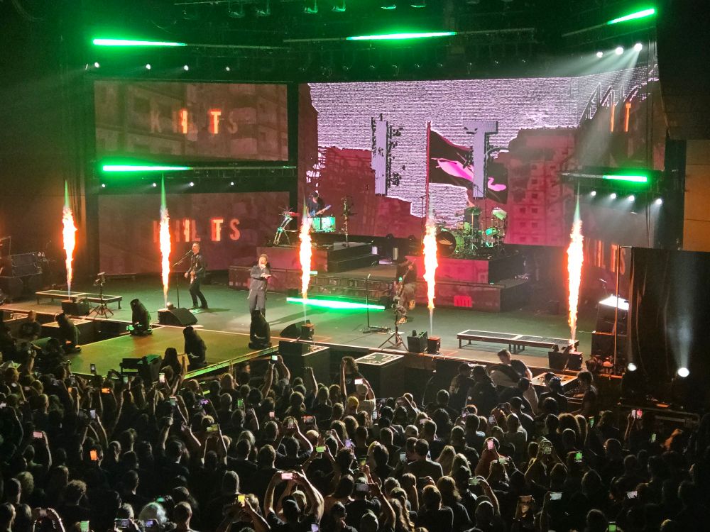 Music band Papa Roach performing on stage in front of crowd. 