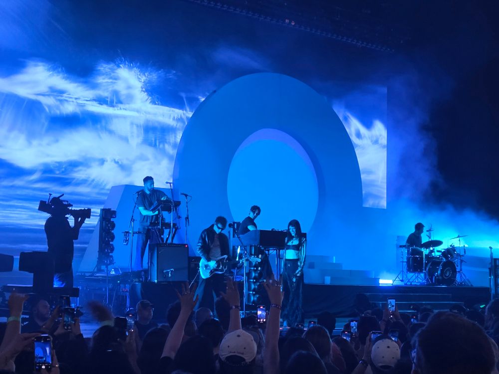 Music band The Marias performing on stage in front of crowd. 