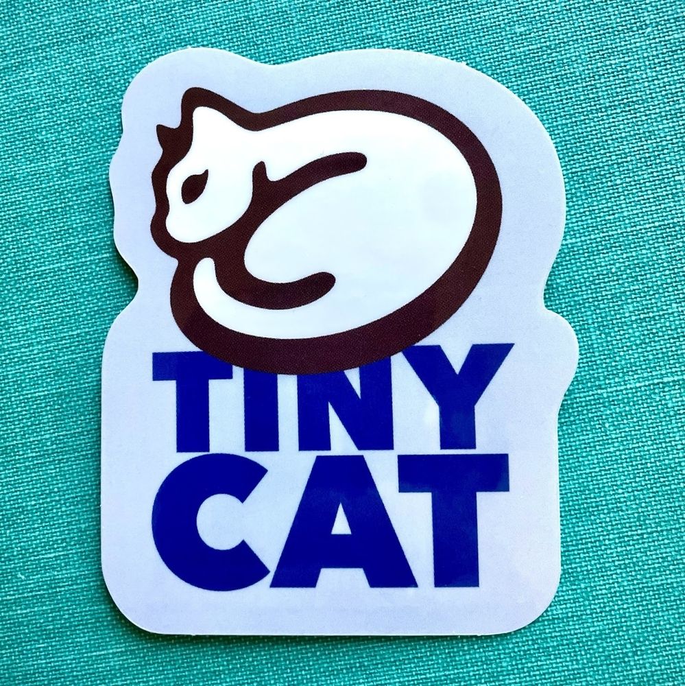 A photograph of a TinyCat sticker.