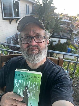 A photograph of our giveaway winner, mahsdad on LibraryThing, who is holding Britt-Marie Was Here by Fredrik Backman.
