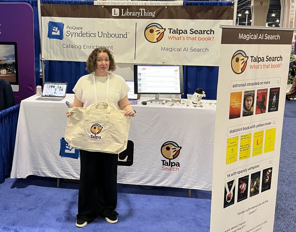 A photograph of LibraryThing staffer Abby holding a Talpa Search tote bag, at the ALA conference.