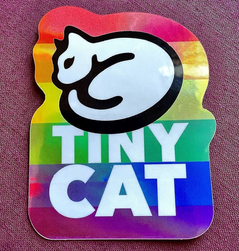 Photograph of a rainbow sticker, showing the TinyCat logo and the word TinyCat.