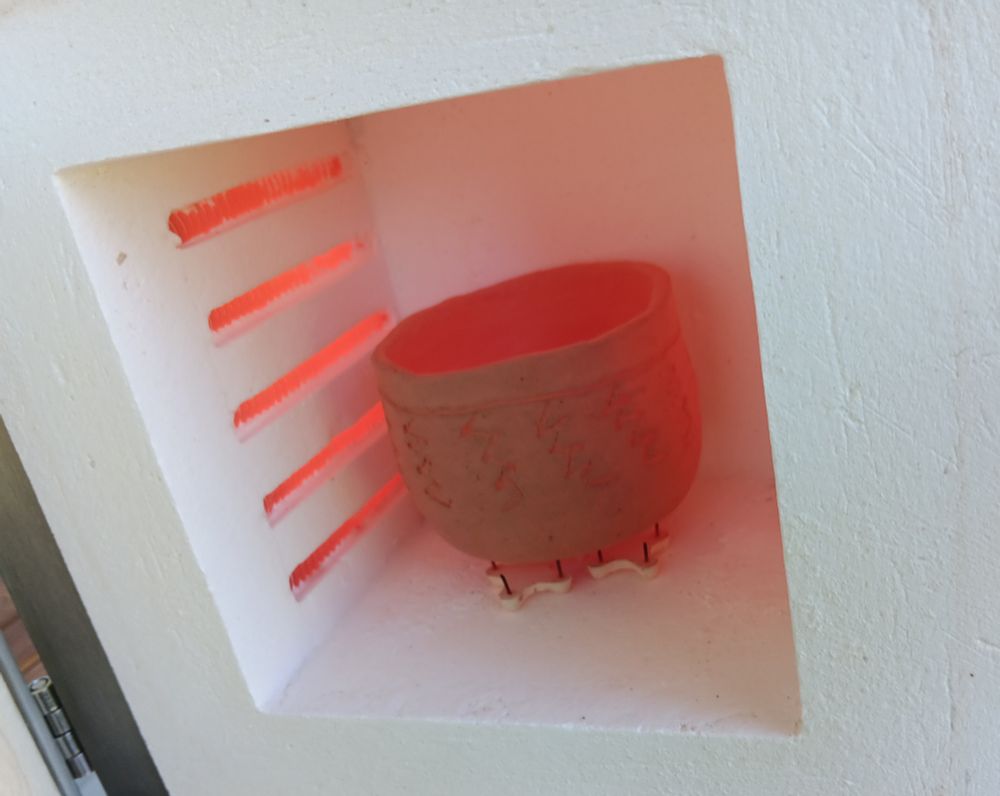 Small cup-like clay pot in kiln.