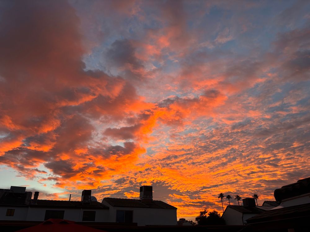 A stunning sunrise with apartment buildings in the foreground 