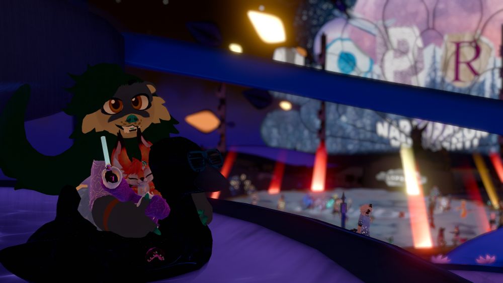 Reaza: North American River Otter Kodiak Bear
Hueyz: Fennec Fox

Reaza and Huey sitting together on a duck pool toy. They are both enjoying Furality's Club F.Y.N.N. together, watching the giant DJ screen and dancing crowd behind them.