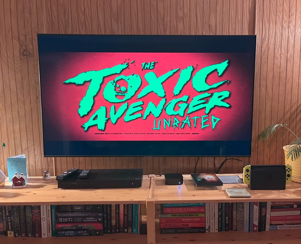 Image of a TV showing the title screen for Toxic Avenger Unrated  