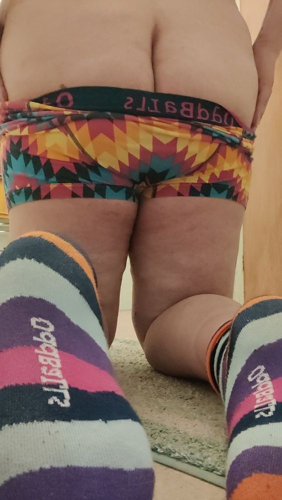 On my knees, pulling underwear down, fat arse visible