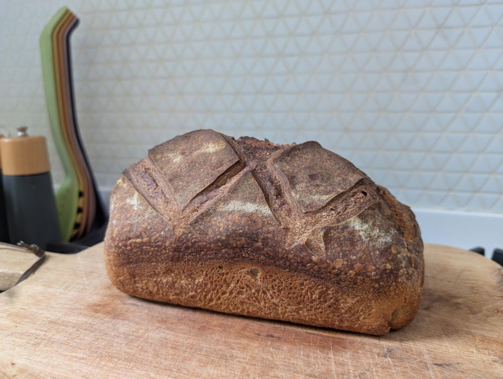 Sourdough loaf on wooden chopping board