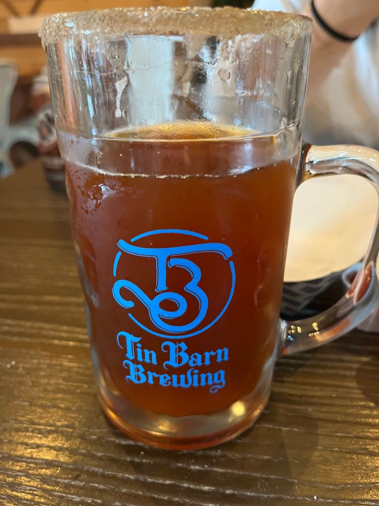 Beer in a glass stein with the inscription “Tin Barn Brewing” written on it. 