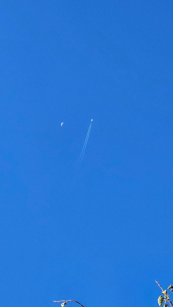 bluesky with a moon and a plane