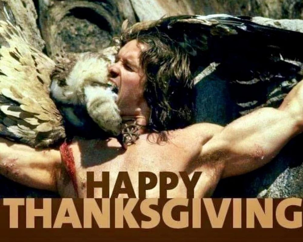 A picture from a scene in the film Conan the Barbarian (1980). Arnold Schwarzenegger as the title character is crucified. He is biting the neck of a vulture that was pecking at him. The picture is captioned happy Thanksgiving.