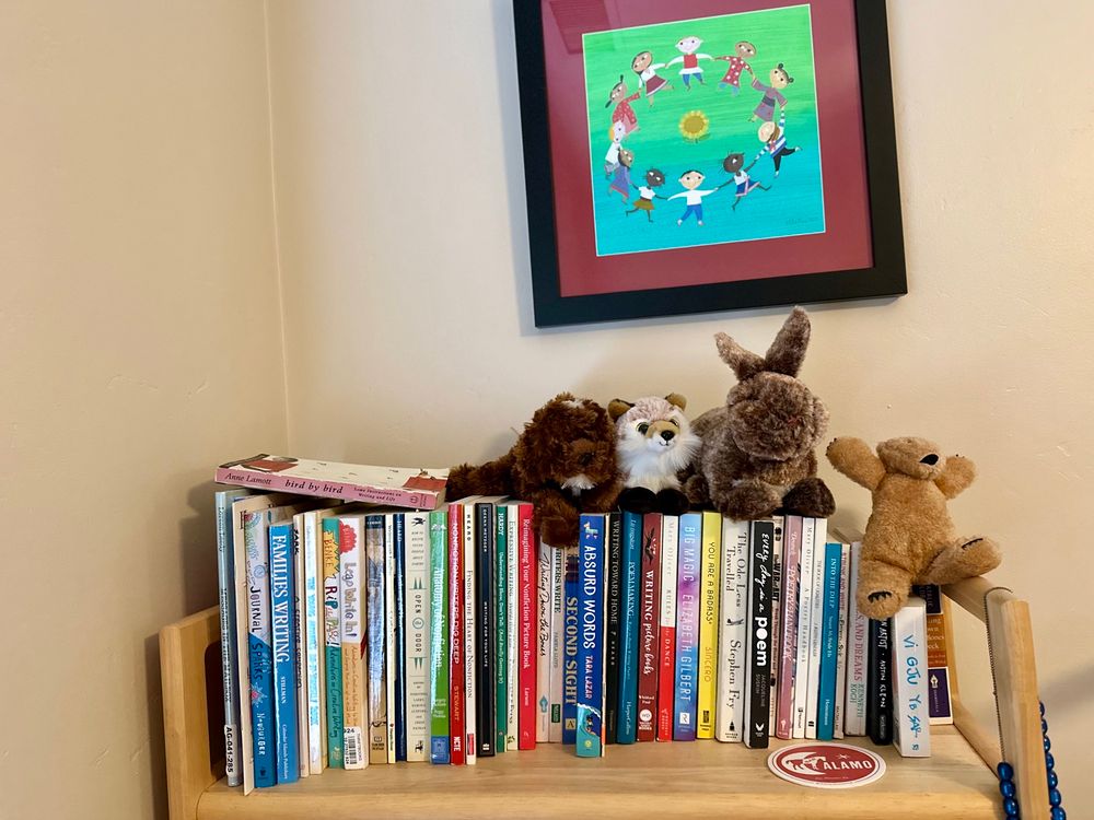 Books on a bookshelf with stuffed animals.