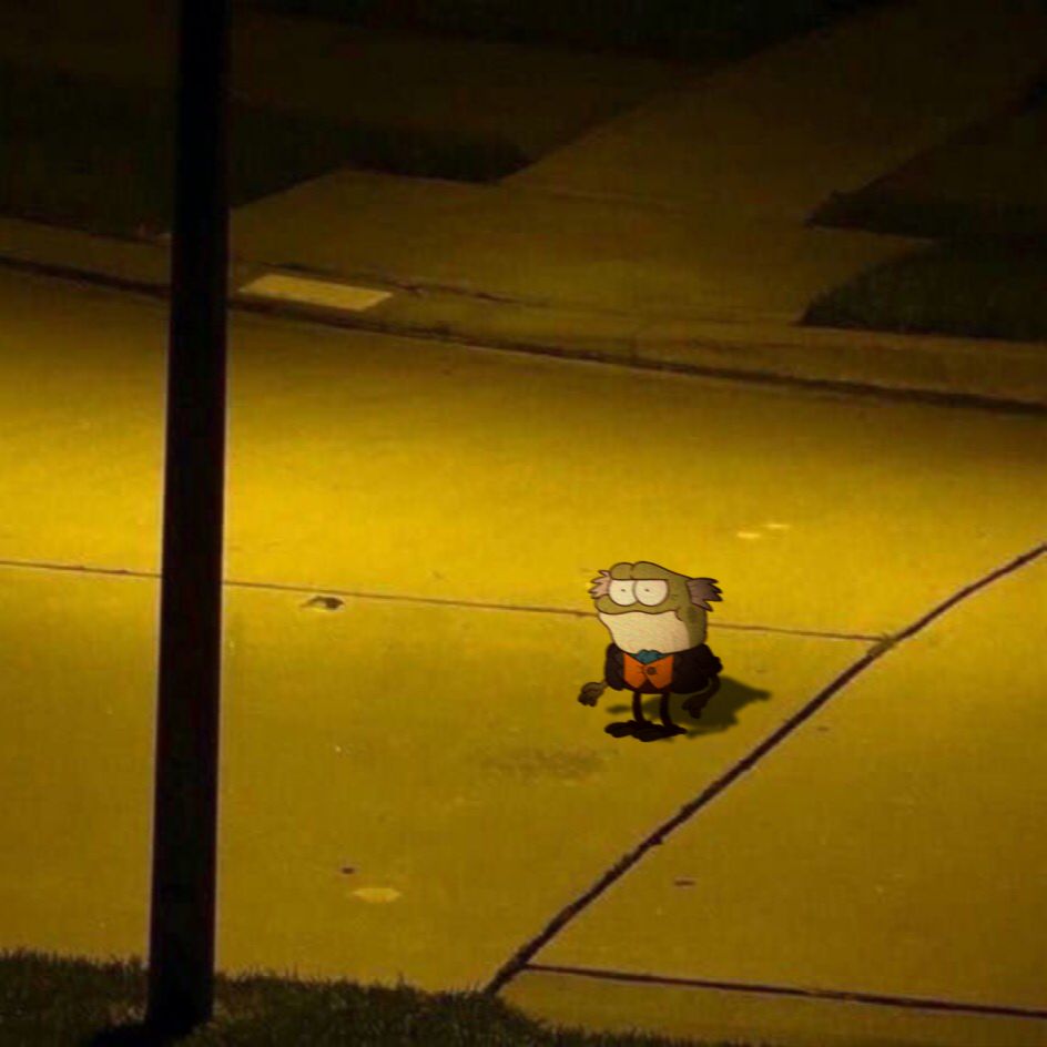 An edited picture of a green version of Hop Pop from Disney's "Amphibia" standing in the middle of a street at night in a menacing fashion.