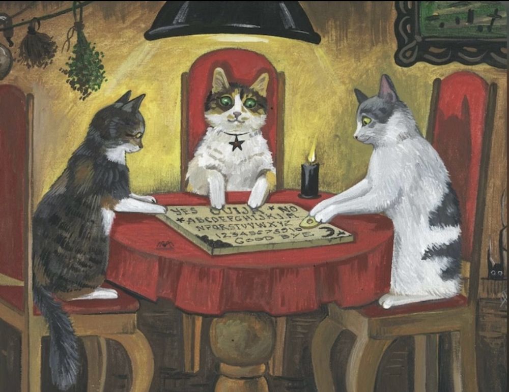 Illustration of three cats sitting around a table with a ouija board. 