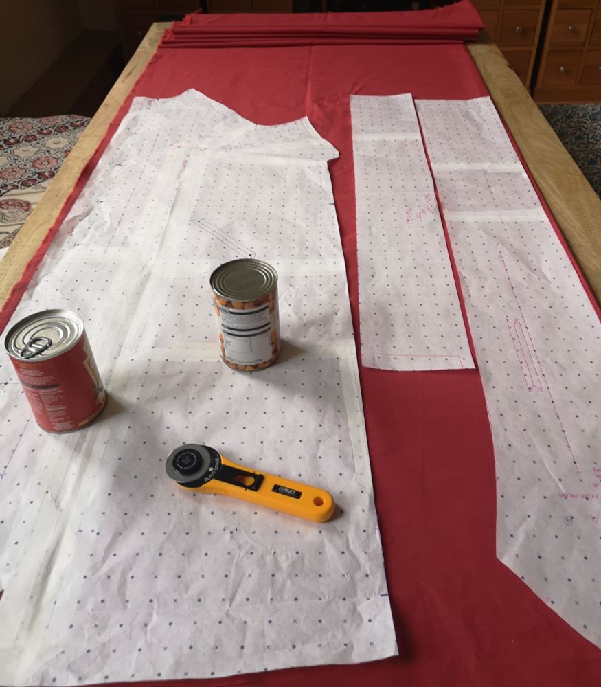 Photo of pattern pieces and a rotary cutter laid out on fabric